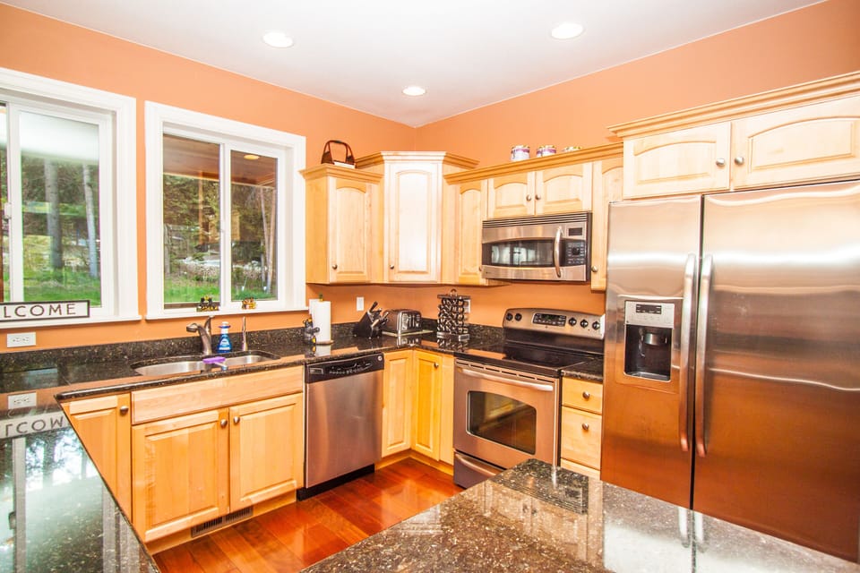 Large kitchen with modern appliances and plenty of dishes.