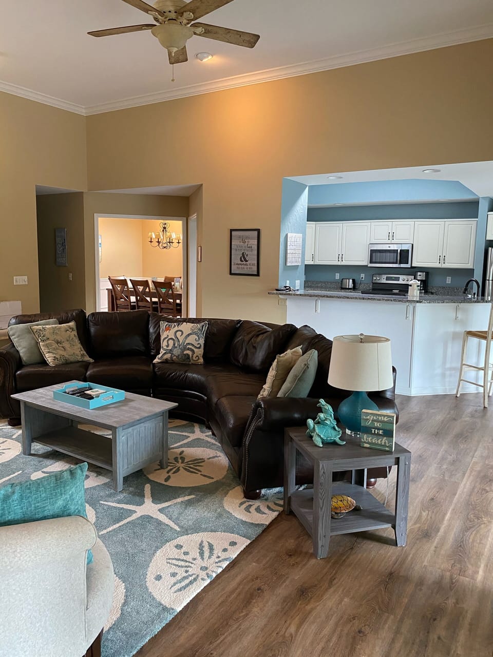 Main living room with all new flooring and area rugs.