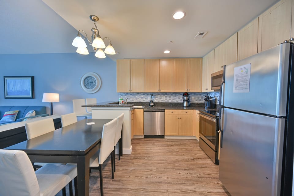 Sleek kitchen with large island and modern lighting