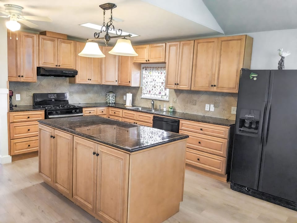 Well stocked kitchen with microwave, gas stove and oven.