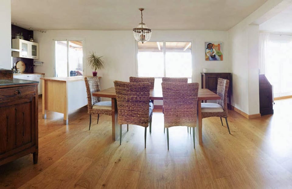 Dinner room with a large wooden table and sea views.