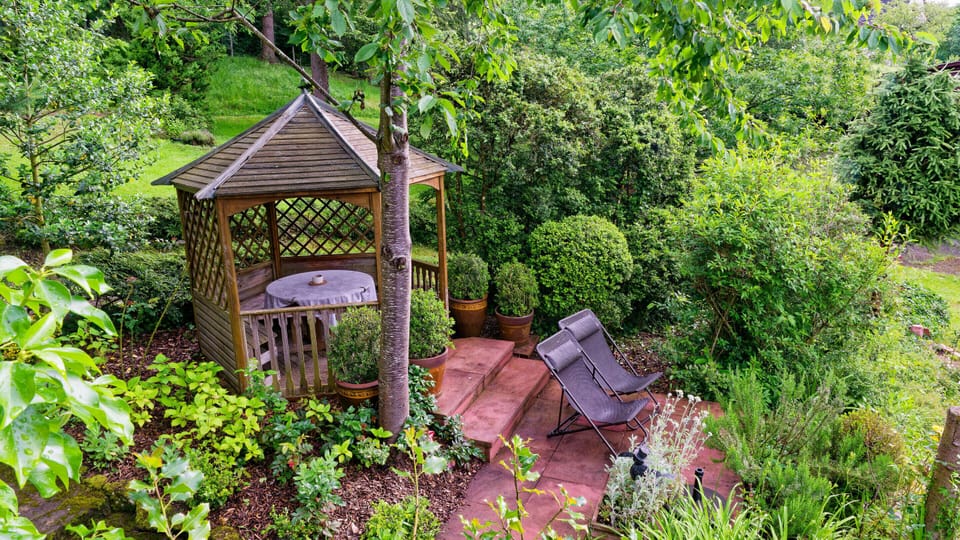 In our garden, a small terrace with a gazebo is reserved for the guests of our holiday apartment.