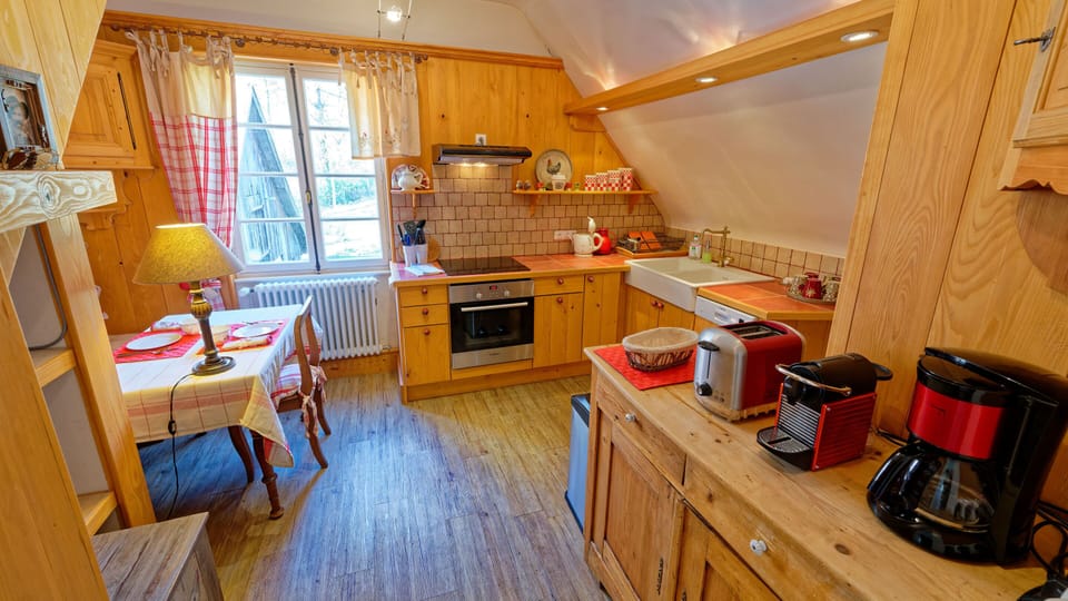 The spacious and well-equipped kitchen has garden and mountain views.