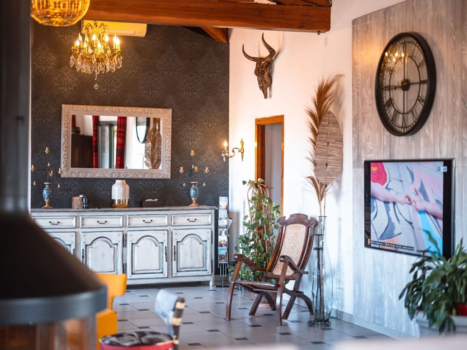 Living room with large sofa - TV screen (165cm) - Dining table for 12 people - Large central fireplace (wood provided as required)
