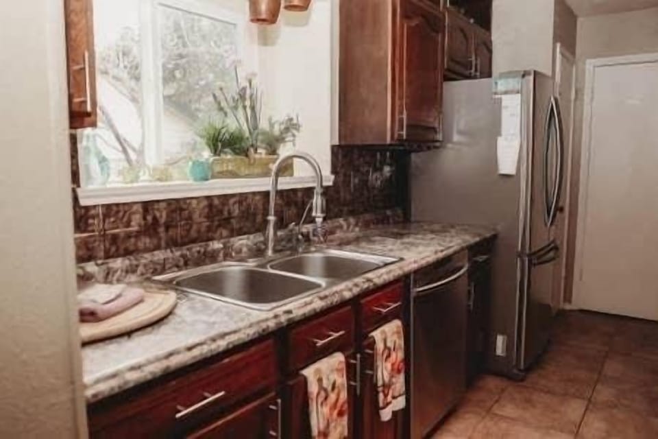 Kitchen sink with Reverso Osmosis faucet, dishwasher, and full size fridge!