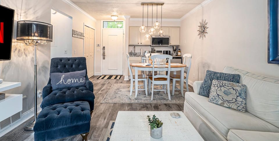 The unit comprises a living area, dining space, and kitchen for a seamless living and dining experience.