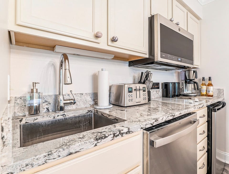 The unit features a dining table for four and a fully-equipped kitchen for your dining needs.