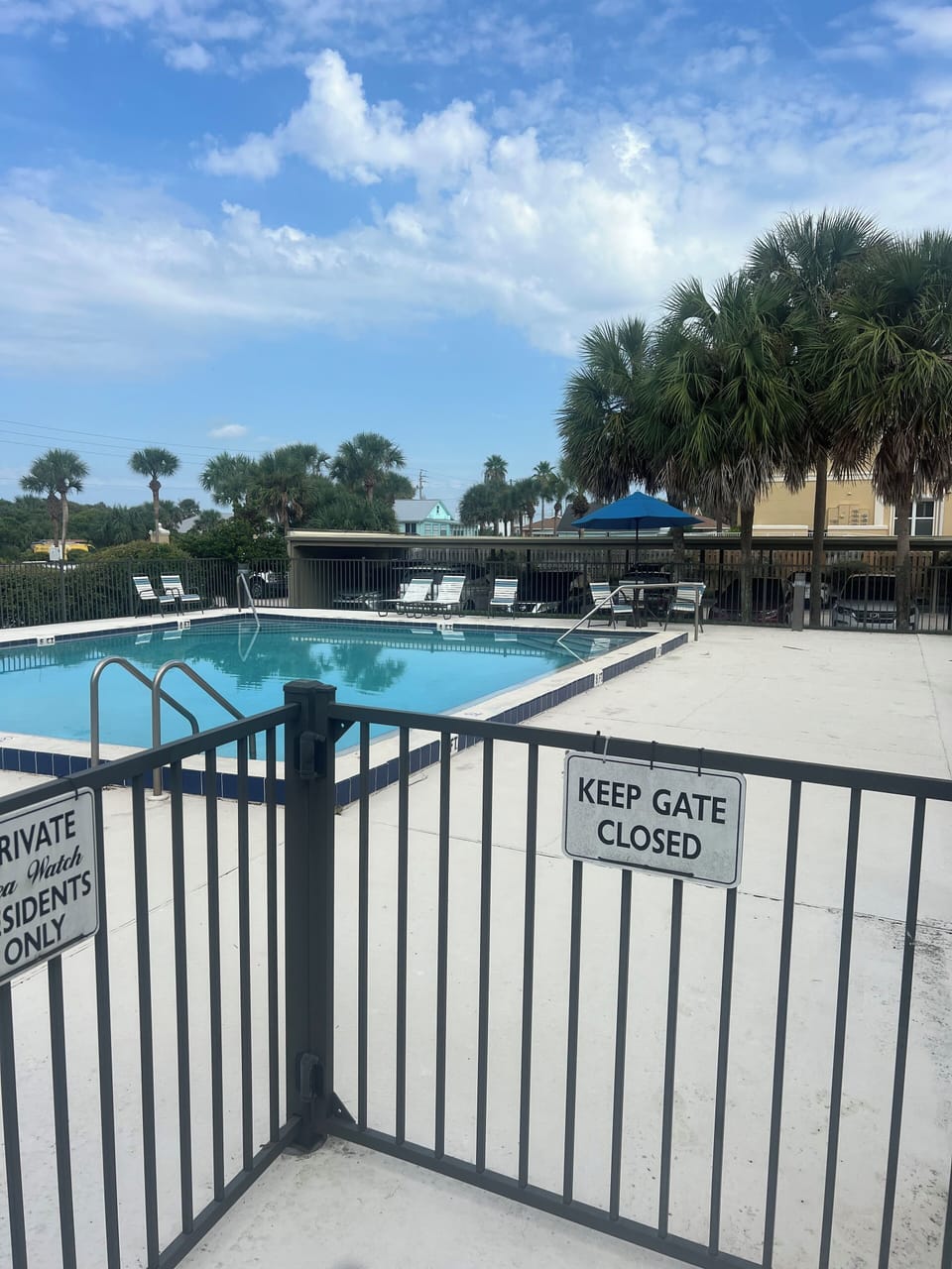 Seawatch Community Pool - complete with lounge chairs and tables with umbrellas