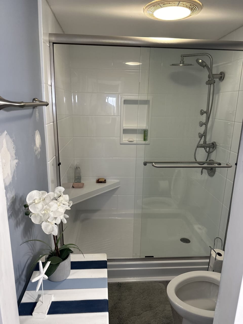 Spa like shower with rain shower and multiple massaging jets. Shower seat 