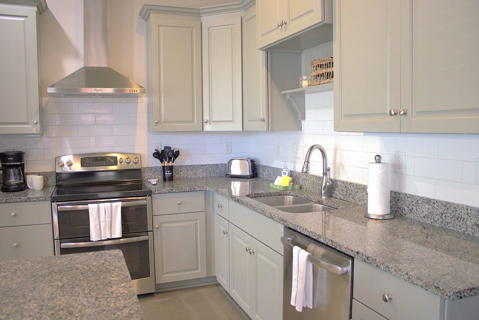 A white subway tile backsplash and organized workspace add to its stylish design.