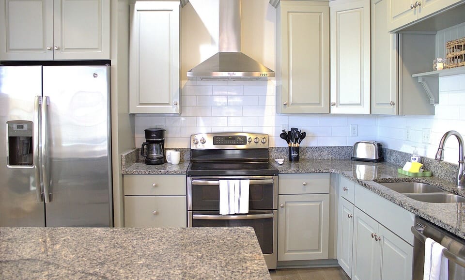 Modern kitchen with stainless steel appliances, granite countertops, and soft gray cabinetry. A functional and stylish space!
