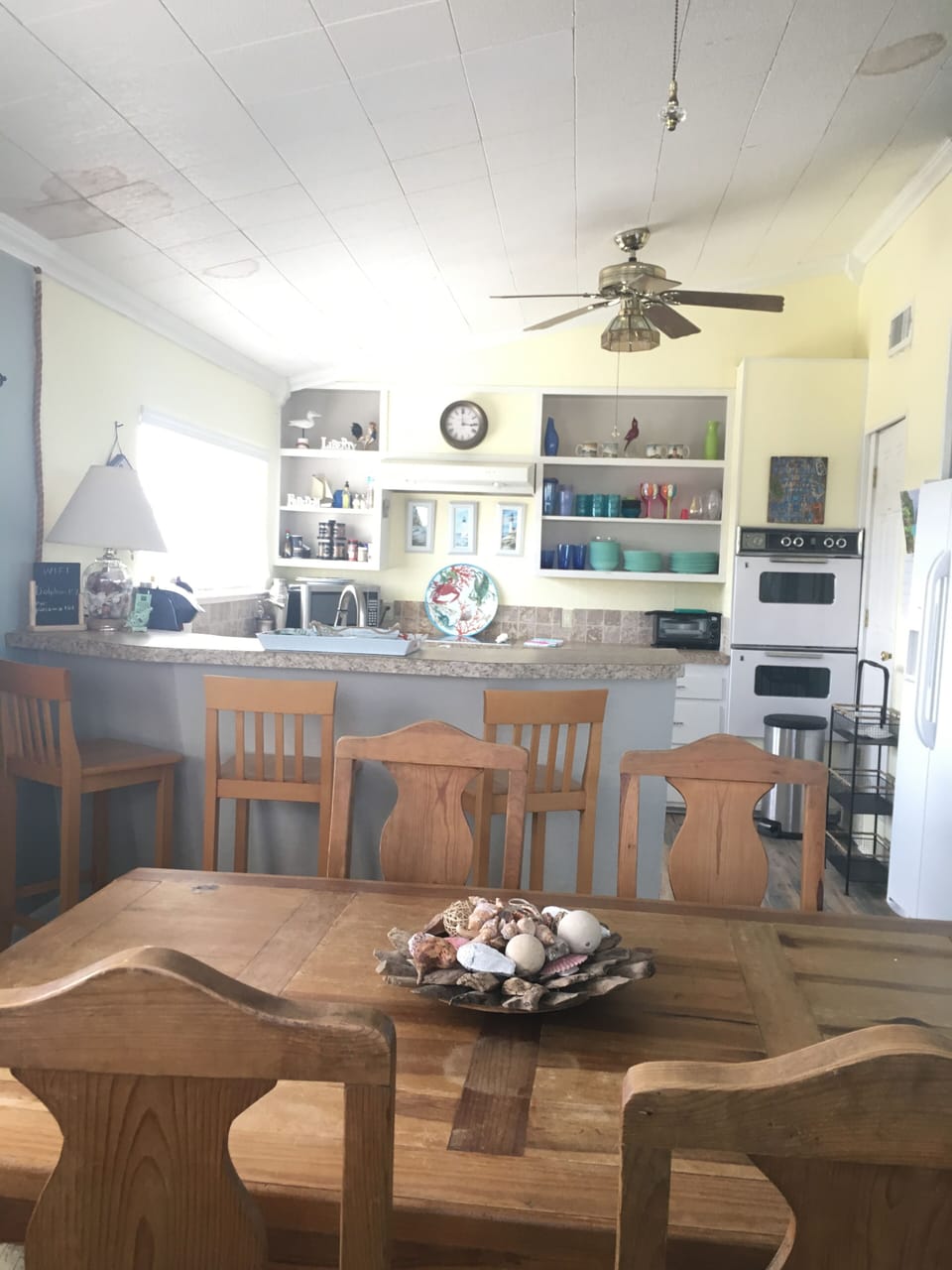 View into kitchen.  Electric stove, oven and dishwasher 
