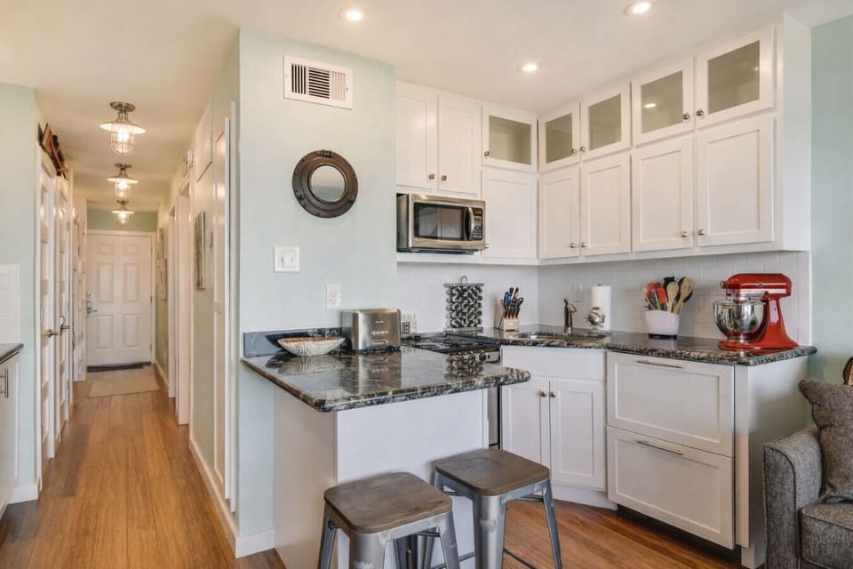 Open-concept living flows into the kitchen and hallway—easy for family-friendly stays and quick resets between beach days on Galveston Island.