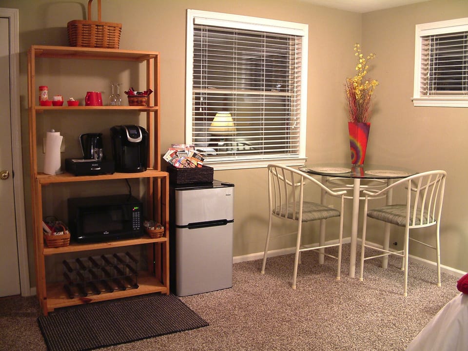 Close up of eating area, refrigerator, and coffee bar