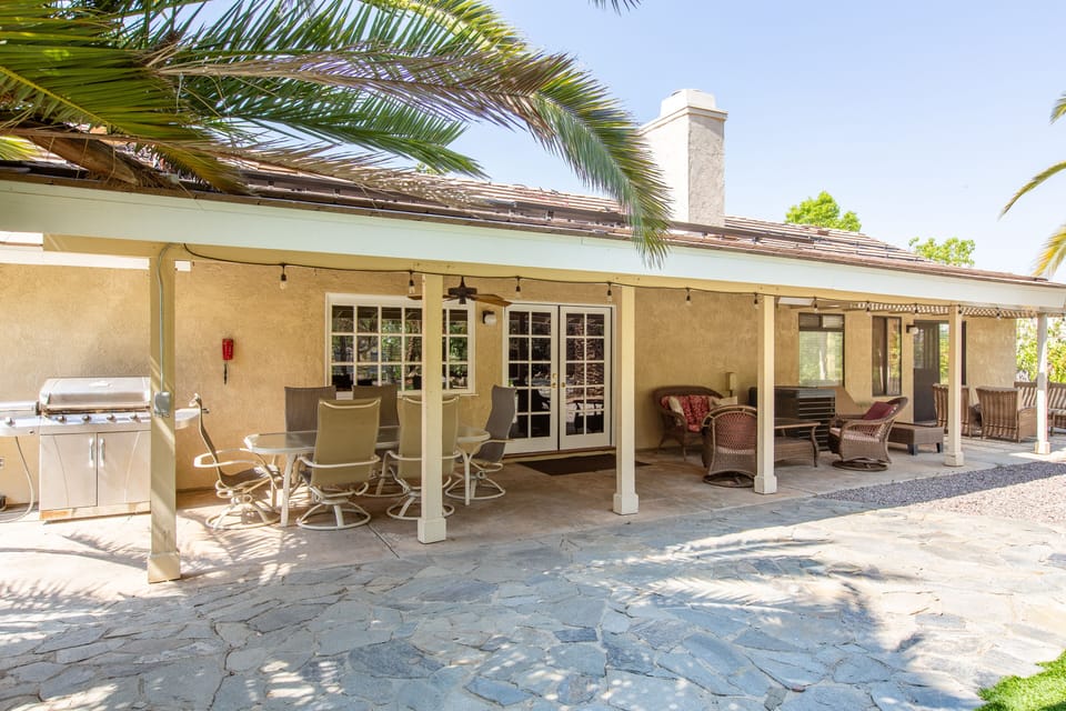 View of seating areas under the covered patio overlooking the Pool & Golf areas.