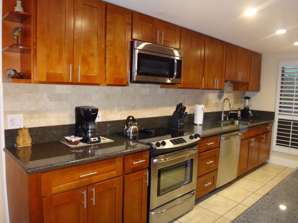 Immaculate designer kitchen featuring custom cabinetry and new appliances