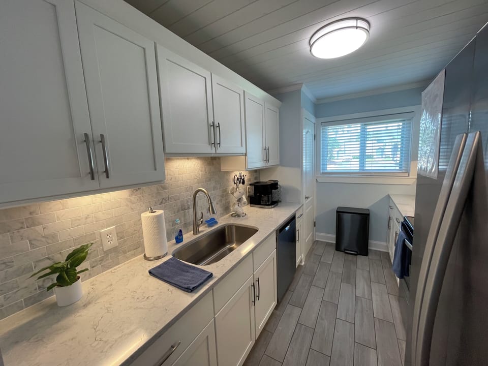 Kitchen with marble counter tops and stainless steel appliances