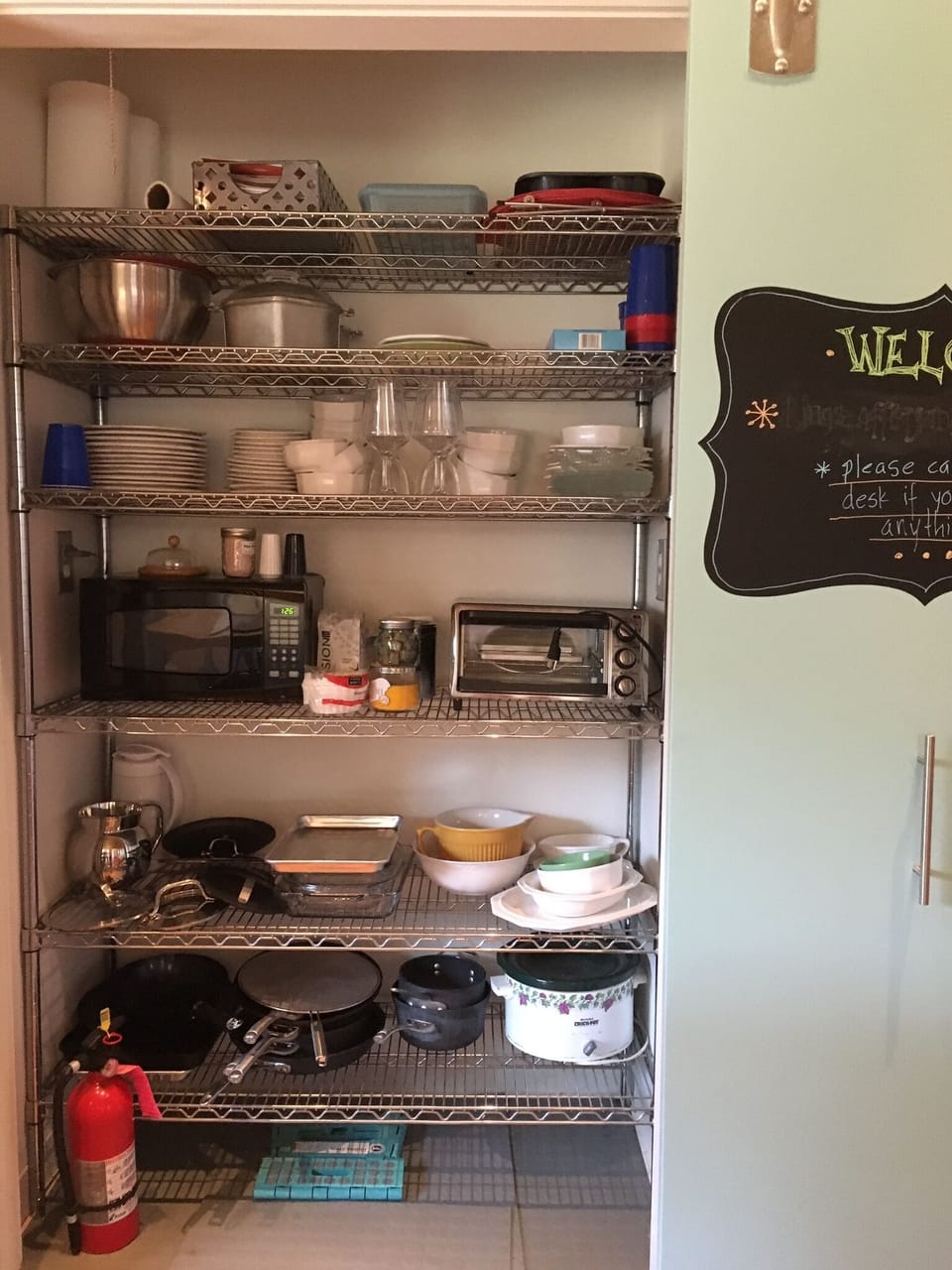 Kitchen closet with details of pots, pans, kitchenware, utensils, etc

