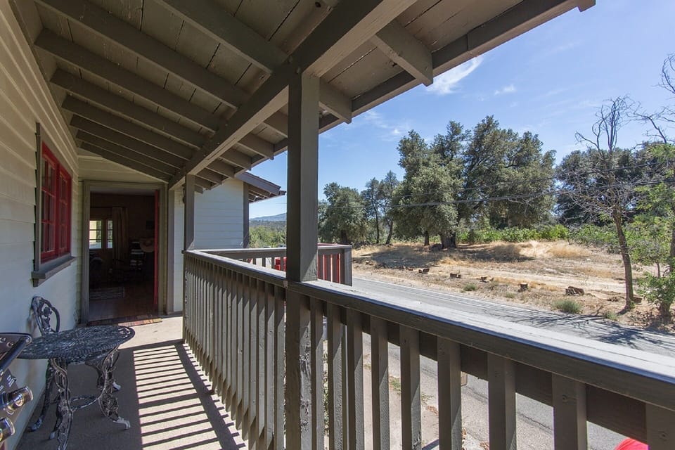 The Loft veranda overlooking native oak trees and a lilac grove.