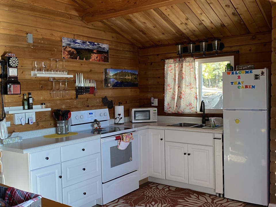 Kitchen has a microwave and an assortment of kitchen appliances.