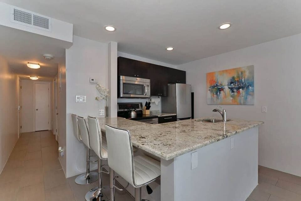 Kitchen: Enjoy cooking in this modern space with sleek granite counters and stylish seating!