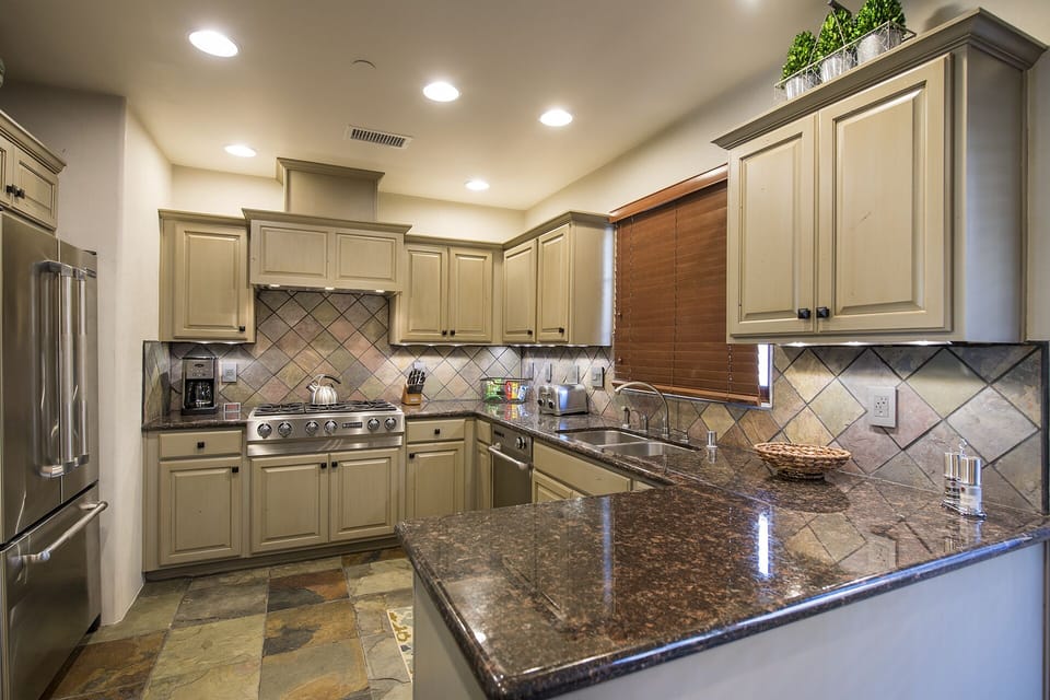 Kitchen with Jenn Aire stainless appliances including 6 burner range