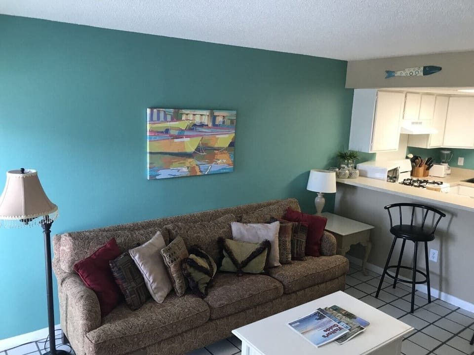 A large plush coach opposite the large TV in the living area.