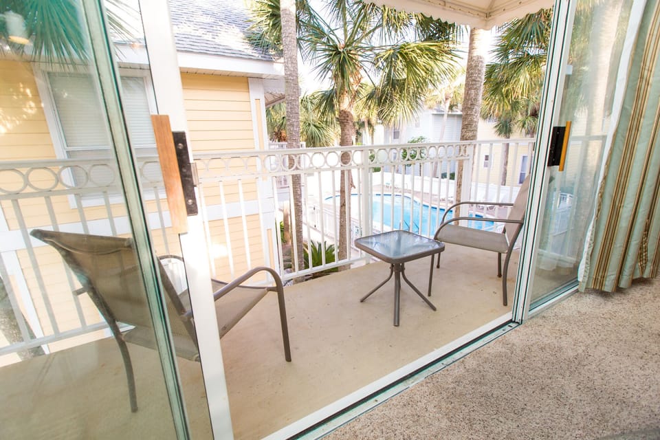 A porch that overlooks the pool with partial gulf view.