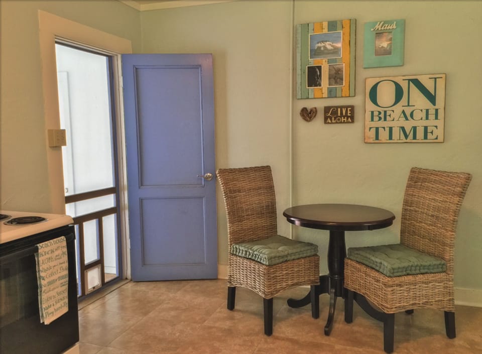 Sitting area in the kitchen; screen door opens to lanai, outside dining table