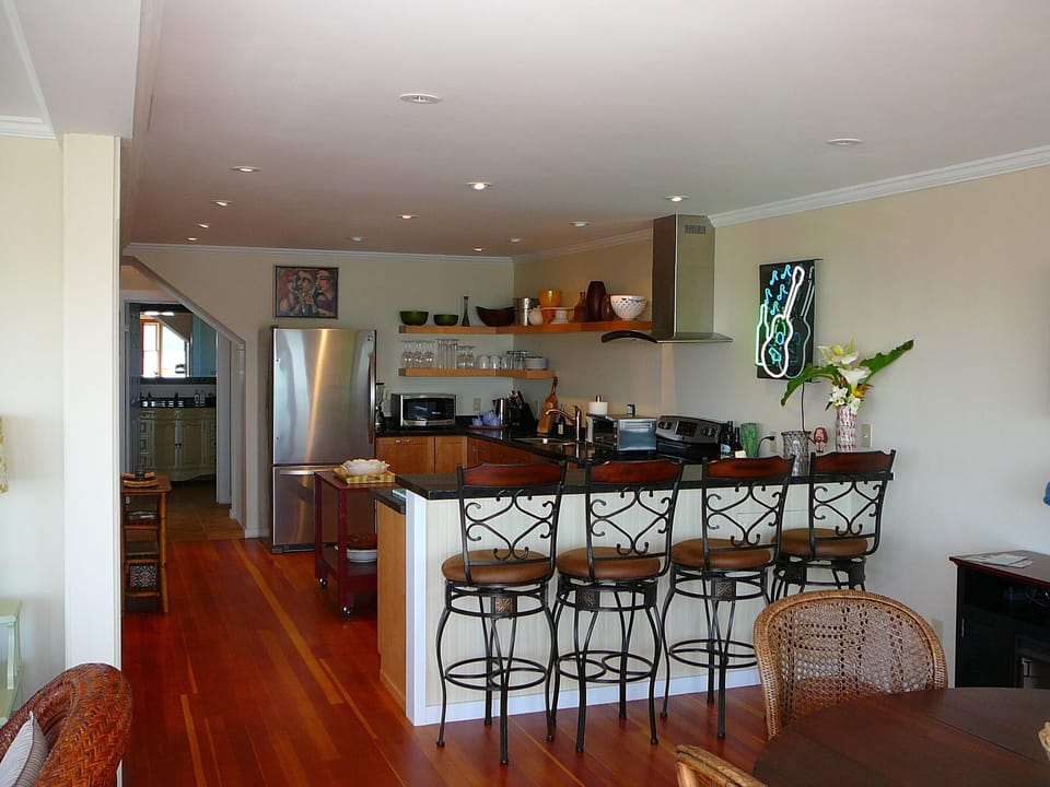 THE KITCHEN & BAR ARE APPOINTED WITH STAINLESS STEEL APPLIANCES & OPEN SHELVING!