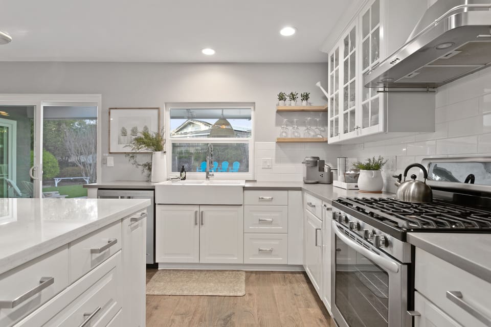 Kitchen with a view of outdoor dining + backyard.