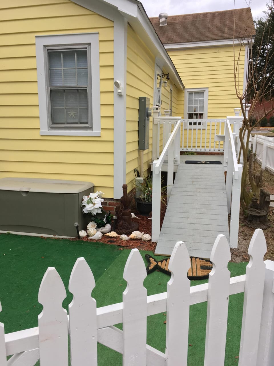 Side porch with ramp at back door entrance. Fenced in back  & side yard .