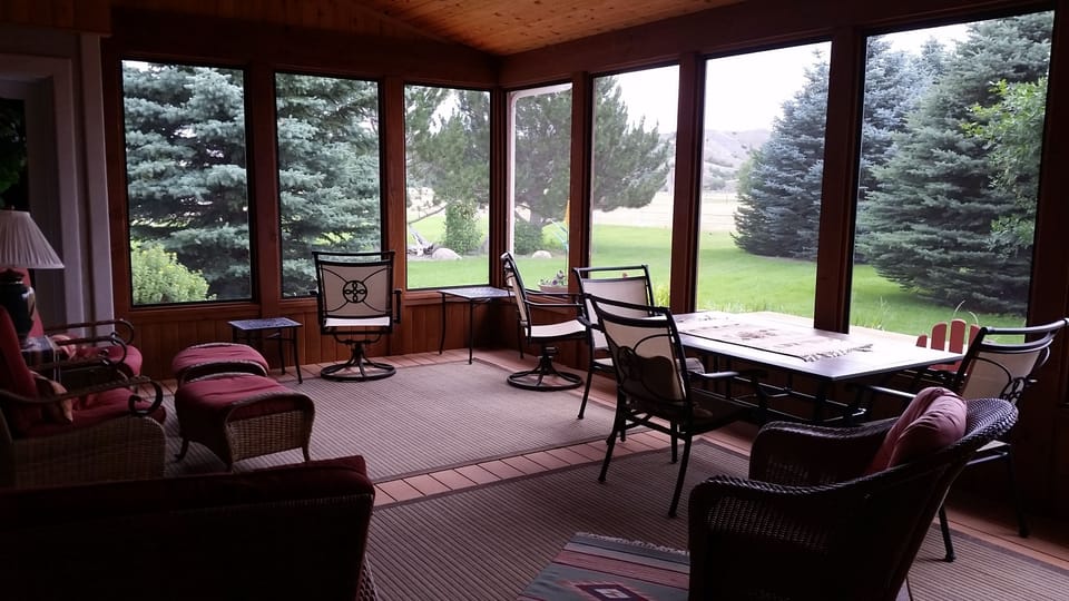 Comfortable patio furniture on screened in porch