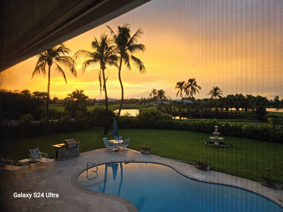 Magnificent sunset views from screened porch overlooking pool and golf course.