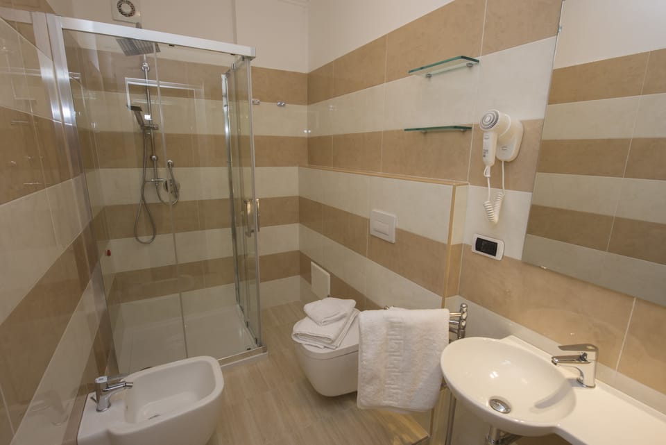 Suite, Balcony, Sea View | Bathroom | Rainfall showerhead, free toiletries, hair dryer, bathrobes