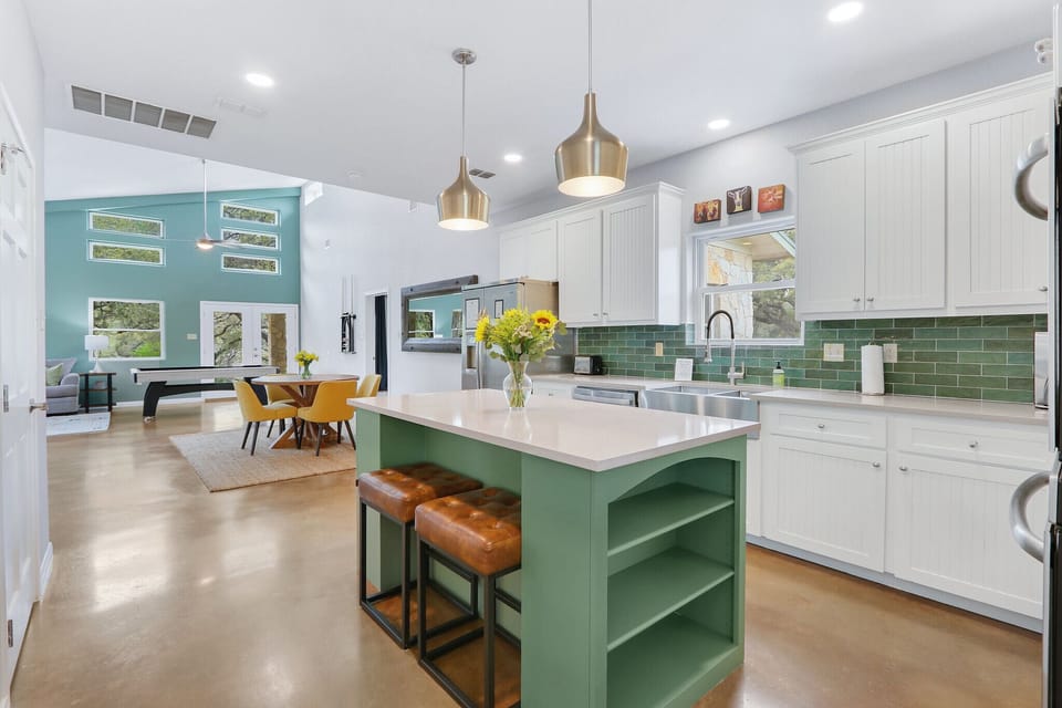 View walking into the home which features an open floor plan connecting kitchen, dining, living and game area.