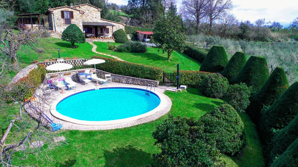 Front view of the villa, pool and lawn