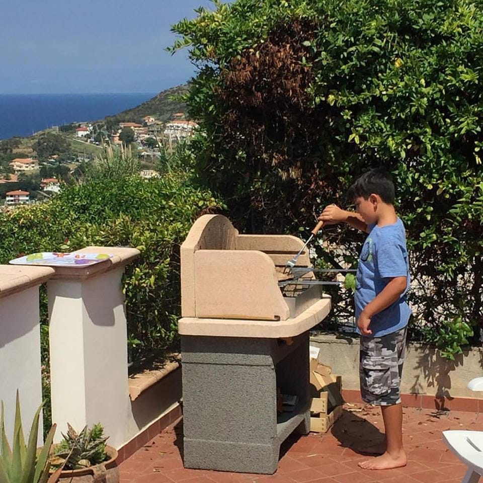 BBQ Master in training on the newly installed stone grill.