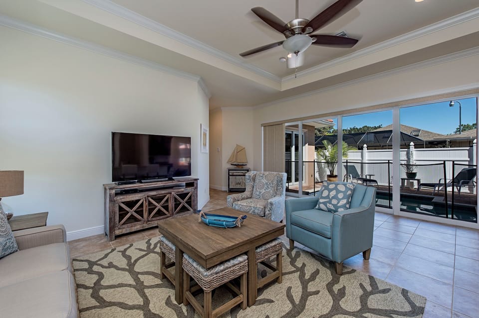 Main Living area 60" HDTV full wall of sliders leading to pool Seats 10