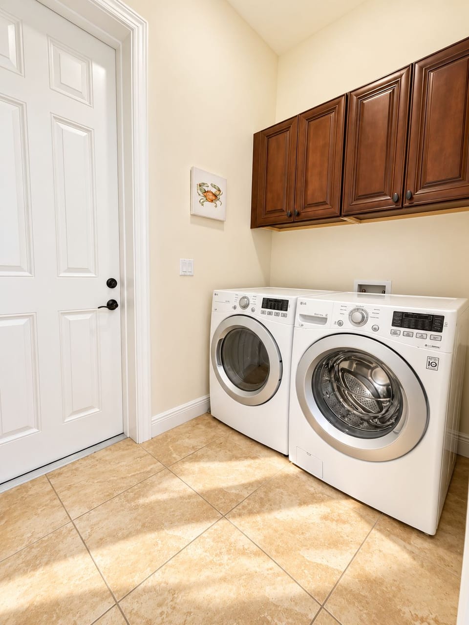 Separate laundry room in home with washer & dryer. Detergent is provided