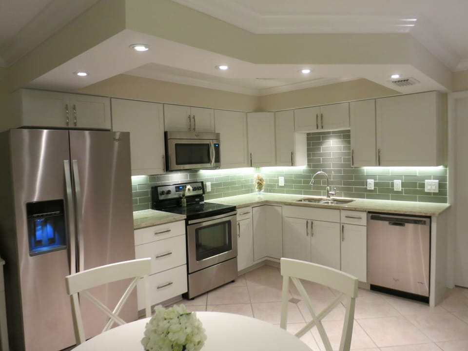 Newly renovated modern kitchen with updated appliances and dining area. 