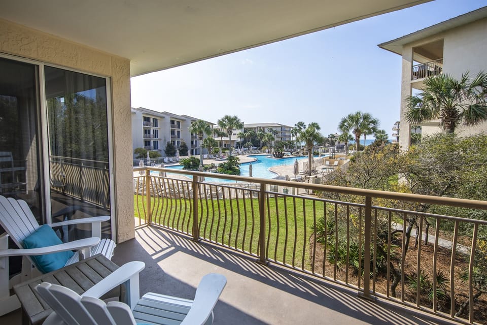 Living room balcony with view of pool and beach
