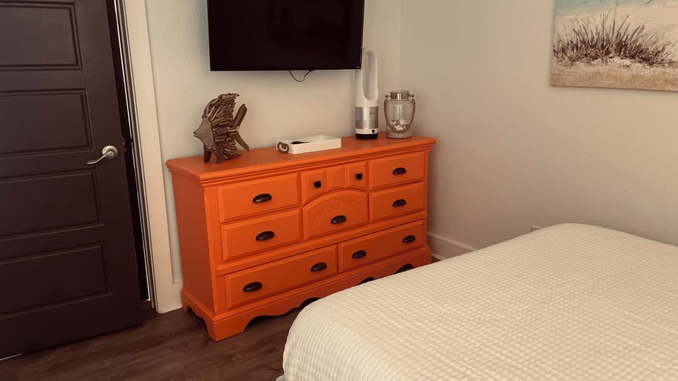 Main floor bedroom with 2 queen beds and 42” flat screen smart TV