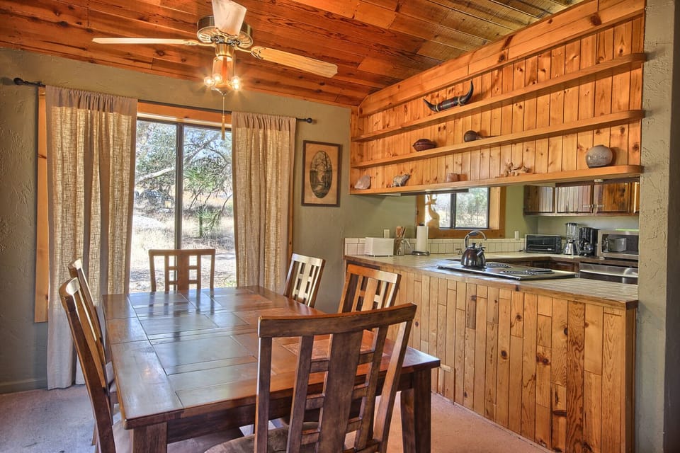 Dining area with a 6-seater table and large windows offering beautiful views.