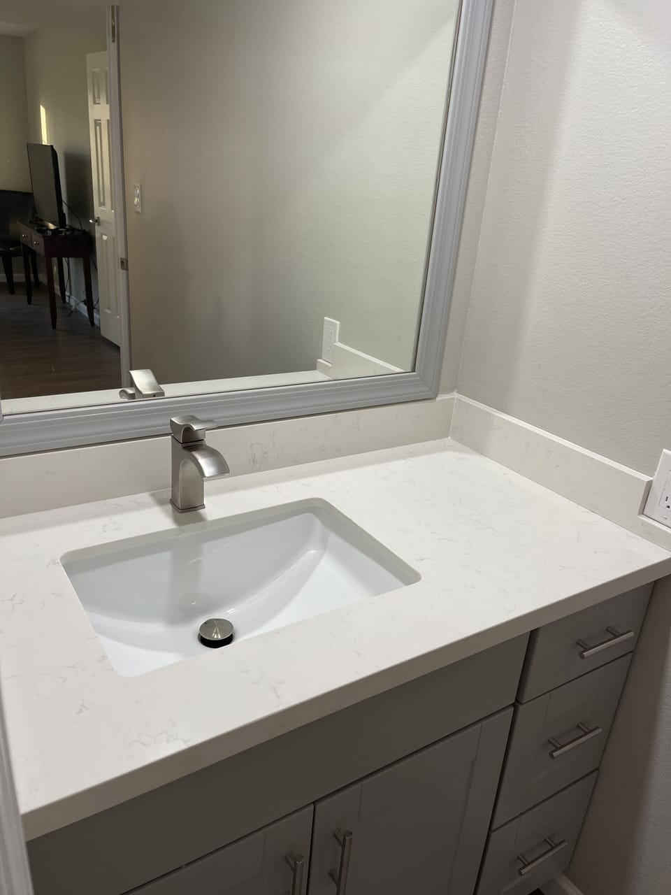 The master bathroom's sink and mirror 