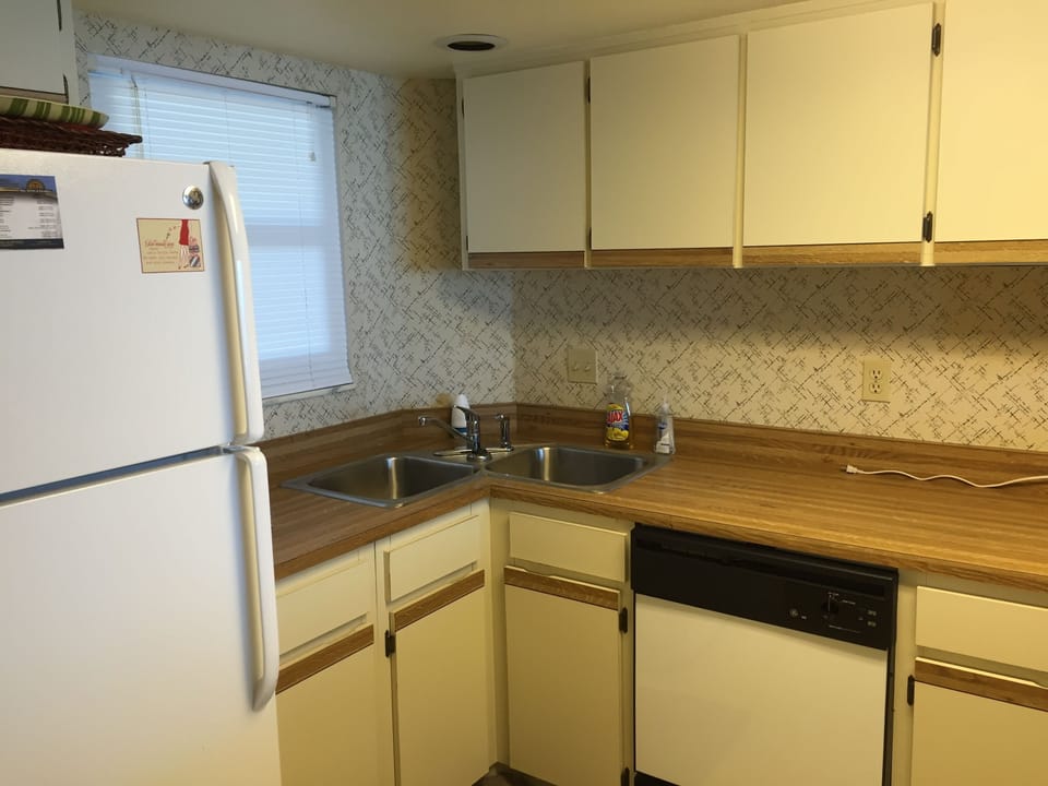 Kitchen has a dishwasher, new refrigerator with ice maker, toaster & microwave