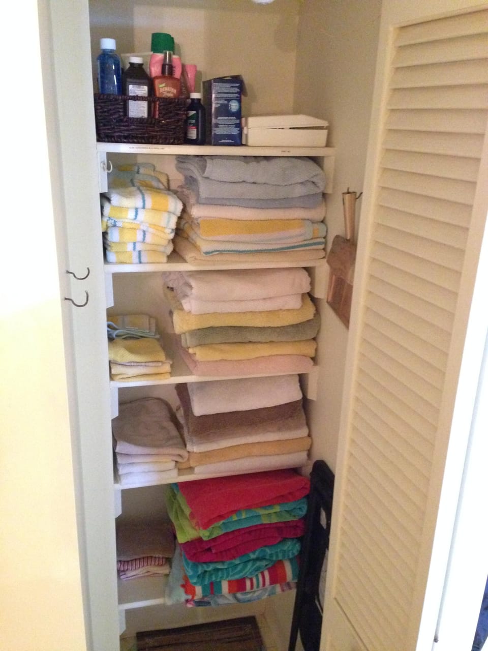 Hall closet holds an abundance of towels, first aid supplies and sunscreen.