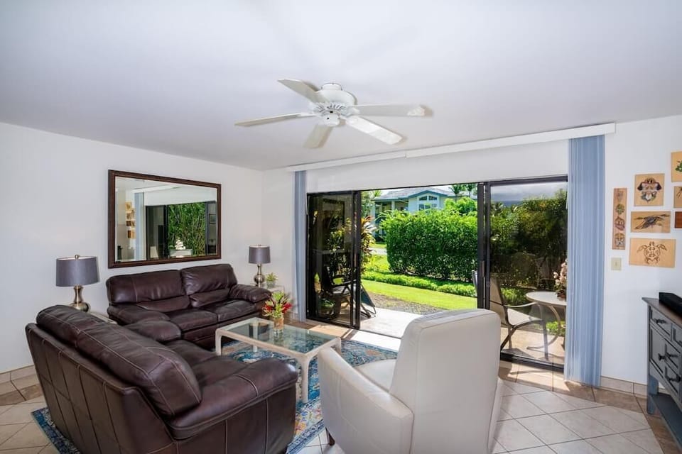 Living Room with Leather Sofas - Ceiling Fan & Tropical Garden Views