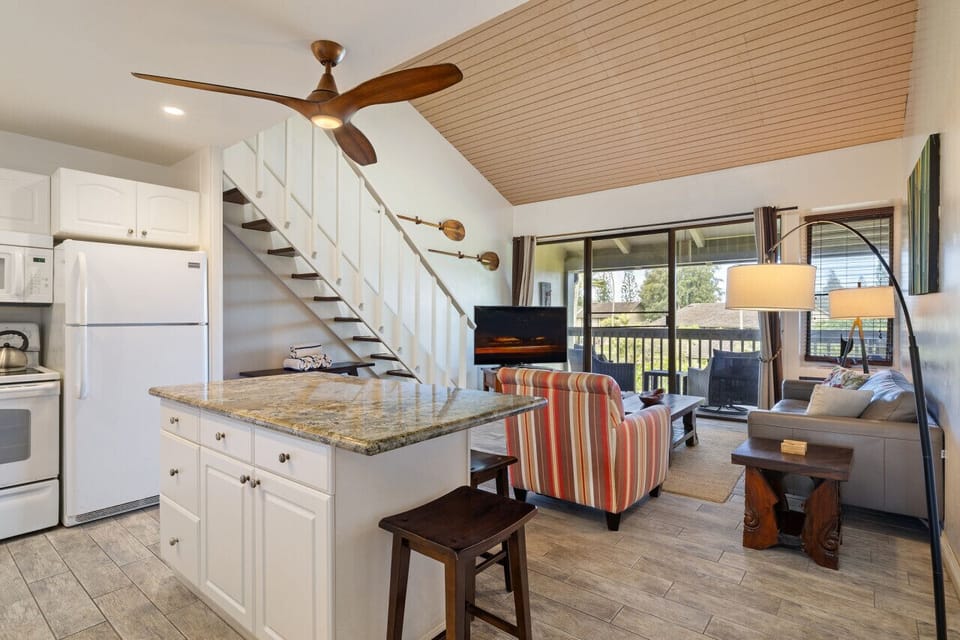 Airy loft-style layout w/ bright kitchen & inviting seating below.