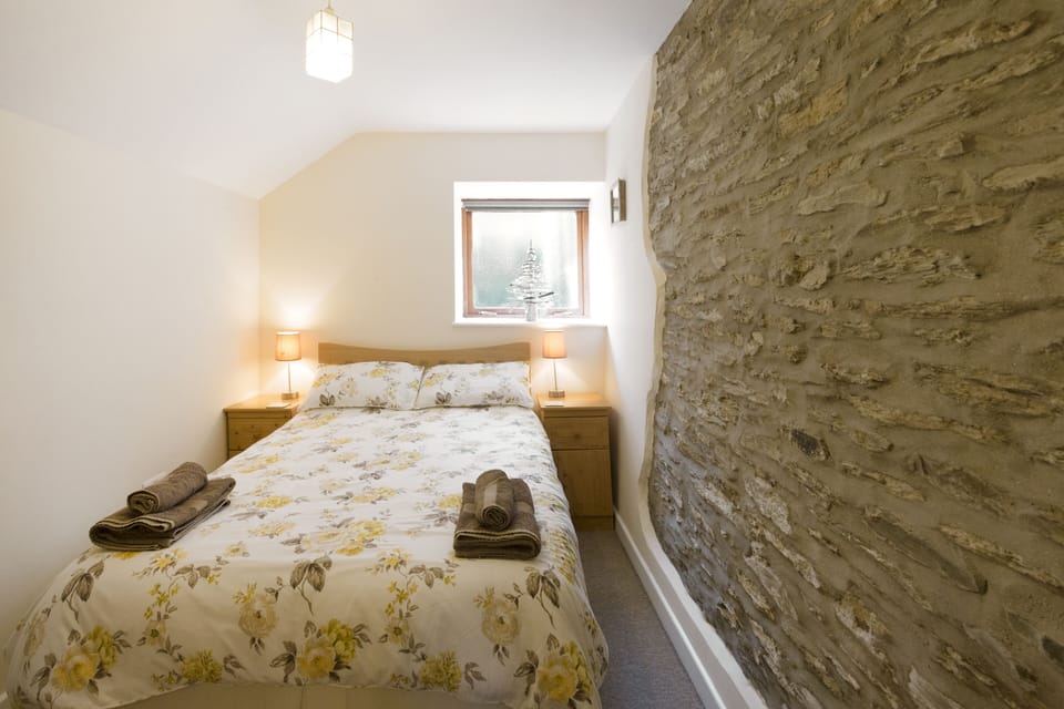 Cosy double bedroom with welsh stone feature wall